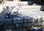 partially built building extension showing 3 rows of breeze blocks marking out the extension plan